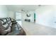 Spacious living area featuring tile floors, a ceiling fan, and sliding glass doors to an outdoor patio at 3442 Monaco Ln, Davenport, FL 33897