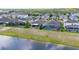An aerial shot of the property in its neighborhood featuring the backyard and lake at 3698 Cortland Dr, Davenport, FL 33837