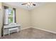 Cozy bedroom with neutral tones, a ceiling fan, carpeted floor, and a bright window with a curtain at 3698 Cortland Dr, Davenport, FL 33837