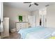 Bedroom with light blue bedding and view to a walk-in closet and ensuite bathroom at 3698 Cortland Dr, Davenport, FL 33837