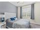 Comfortable bedroom with stylish headboard, gray bedding, side table and soft natural light from the window at 3698 Cortland Dr, Davenport, FL 33837