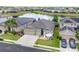 Well-maintained home exterior with a three-car garage and inviting front patio at 3698 Cortland Dr, Davenport, FL 33837