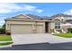 Charming home with a well-manicured lawn, three-car garage, and cozy front patio area at 3698 Cortland Dr, Davenport, FL 33837