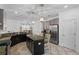 Open concept kitchen with stainless steel appliances, granite countertops, and an island with pendant lighting at 3698 Cortland Dr, Davenport, FL 33837
