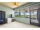 Inviting screened-in lanai featuring tile flooring and a serene view of the lake, perfect for relaxing at 3698 Cortland Dr, Davenport, FL 33837