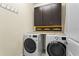 Functional laundry room featuring modern washer and dryer units and convenient storage cabinets at 3698 Cortland Dr, Davenport, FL 33837