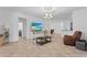 Bright living room with tile floors, ceiling fan, and view into dining room and kitchen at 3698 Cortland Dr, Davenport, FL 33837