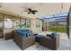 Charming screened patio with comfortable wicker furniture and a tranquil outdoor setting with ample seating space at 3698 Cortland Dr, Davenport, FL 33837