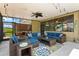 Spacious screened-in patio with cozy seating arrangements, perfect for relaxing and enjoying outdoor gatherings at 3698 Cortland Dr, Davenport, FL 33837