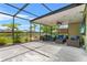 Beautiful patio with an outdoor seating area, perfect for enjoying the lush landscaping and serene waterfront views at 3698 Cortland Dr, Davenport, FL 33837