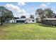 Expansive backyard featuring lush lawn and a screened-in porch, perfect for outdoor relaxation and entertainment at 412 Georgia Ave, St Cloud, FL 34769
