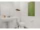 Clean, minimalist half-bathroom with a pedestal sink, modern toilet, and simple decor at 4736 Homestead Trl, St Cloud, FL 34772