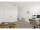 Bright, carpeted bedroom featuring a large closet, a window, and various toys at 4736 Homestead Trl, St Cloud, FL 34772
