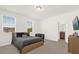 Bedroom features a plush bed, a sunny window, and a hallway bathroom entrance at 4736 Homestead Trl, St Cloud, FL 34772