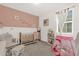 Charming Bedroom with pink accents, including a cute crib and tent, perfect for a little one at 4736 Homestead Trl, St Cloud, FL 34772