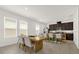 Bright dining area with an adjacent kitchen featuring stainless steel appliances and dark cabinetry at 4736 Homestead Trl, St Cloud, FL 34772