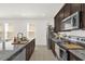 Modern kitchen with stainless steel appliances, granite countertops, and tiled floors at 4736 Homestead Trl, St Cloud, FL 34772