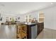 Modern open-concept kitchen featuring granite countertops, dark wood cabinets, and a large center island at 4736 Homestead Trl, St Cloud, FL 34772