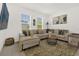 Bright living room featuring a large sectional couch, stylish rug, and an abundance of natural light at 4736 Homestead Trl, St Cloud, FL 34772