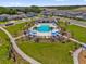 Aerial view of a community pool surrounded by palm trees, lounge chairs, and umbrellas at 4736 Homestead Trl, St Cloud, FL 34772
