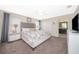 This bedroom offers carpet floors, a king bed, ceiling fan and ensuite bathroom at 4903 Windermere Ave, Kissimmee, FL 34746