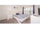 Cozy bedroom features a comfortable queen-size bed, soft carpet, and ample natural light from the window at 4903 Windermere Ave, Kissimmee, FL 34746