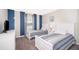 This cozy bedroom features two twin beds, carpet floors and stylish blue accents at 4903 Windermere Ave, Kissimmee, FL 34746