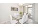 Stylish dining room featuring a modern glass table, seating for six, and a contemporary chandelier at 4903 Windermere Ave, Kissimmee, FL 34746