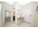 A modern entryway showcases neutral colors, marble floors and access to the Primary suite at 4903 Windermere Ave, Kissimmee, FL 34746