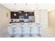 Modern kitchen island with breakfast bar seating, pendant lighting, and sleek appliances at 4903 Windermere Ave, Kissimmee, FL 34746