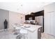 Modern kitchen with black cabinets, stainless steel appliances, breakfast bar and pendant lighting at 4903 Windermere Ave, Kissimmee, FL 34746