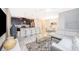 Open-concept living space featuring kitchen with island, dining area and living room with contemporary furnishings at 4903 Windermere Ave, Kissimmee, FL 34746