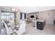 Spacious open-concept layout features kitchen, dining, and living areas with modern furnishings and access to the screened lanai at 4903 Windermere Ave, Kissimmee, FL 34746