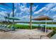Relaxing lakeside patio with ample seating and a shaded gazebo overlooking the serene water at 4903 Windermere Ave, Kissimmee, FL 34746