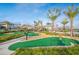 Lush putting green with palm trees and stone paths in a tropical resort-style setting at 4903 Windermere Ave, Kissimmee, FL 34746