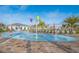 Community splash pad with colorful water features and nearby lounge chairs and palm trees at 4903 Windermere Ave, Kissimmee, FL 34746