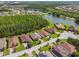 Expansive aerial view showcasing the home's setting within a community surrounded by lush landscaping and serene lakes at 582 San Joaquin Rd, Poinciana, FL 34759