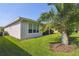 Well-manicured backyard features a screen enclosed lanai, lush lawn, and mature landscaping at 582 San Joaquin Rd, Poinciana, FL 34759