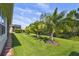 Expansive backyard with lush lawn, mature trees, and privacy, ideal for outdoor activities at 582 San Joaquin Rd, Poinciana, FL 34759
