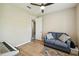 Bedroom with laminate flooring, neutral walls, and a cozy sitting area at 582 San Joaquin Rd, Poinciana, FL 34759