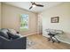 Cozy bedroom featuring a ceiling fan, laminate flooring, and lots of natural light at 582 San Joaquin Rd, Poinciana, FL 34759