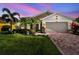 Charming single Gathering home featuring stone accents, paver driveway, a well-manicured lawn and lush landscaping at 582 San Joaquin Rd, Poinciana, FL 34759