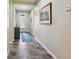 Inviting hallway with tile flooring and a decorative painting at 582 San Joaquin Rd, Poinciana, FL 34759