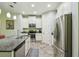 Beautiful kitchen with stainless steel appliances, granite countertops, and white cabinets at 582 San Joaquin Rd, Poinciana, FL 34759