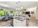 Well-lit kitchen island with granite countertops and stainless steel dishwasher overlooking the dining and living areas at 582 San Joaquin Rd, Poinciana, FL 34759
