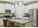 This updated kitchen boasts stainless steel appliances, granite countertops, an island with seating and ample cabinet space at 582 San Joaquin Rd, Poinciana, FL 34759