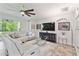 Bright living room featuring a plush sectional sofa, large windows, and contemporary decor at 582 San Joaquin Rd, Poinciana, FL 34759