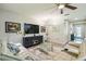 Comfortable living room with large sectional sofa, ceiling fan, entertainment center, and lots of natural light at 582 San Joaquin Rd, Poinciana, FL 34759