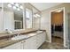 Elegant main bathroom with dual sinks, granite countertops, tile flooring, and a walk-in closet at 582 San Joaquin Rd, Poinciana, FL 34759