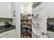 Walk-in pantry with ample shelving and storage solutions, keeping your kitchen organized and clutter-free at 582 San Joaquin Rd, Poinciana, FL 34759